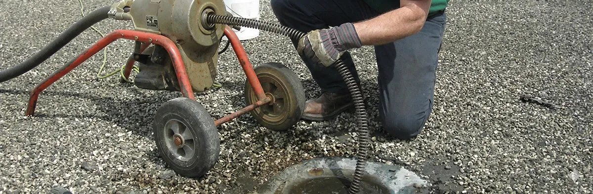 sewer rodding technician actively removing blockages from a sewer line in Charlotte, NC